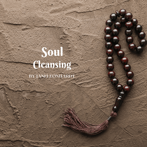 Prayer beads on a textured brown surface with the text 'Soul Cleansing'
